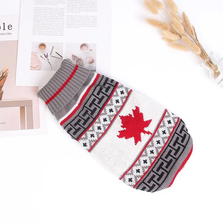 Knit pet sweater with a red maple leaf and gray, black and white patterned bands