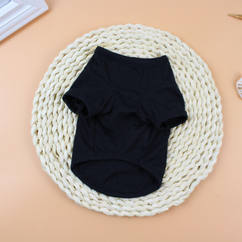 Plain underside of a black pet shirt showing leg openings and curved hem