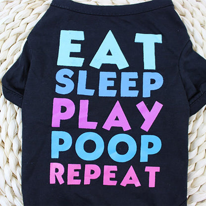 Close up of colorful Eat Sleep Play Poop Repeat lettering on a black pet shirt