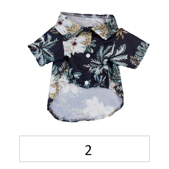 Front view of a black tropical pet shirt with white flowers and pineapple print labeled 2