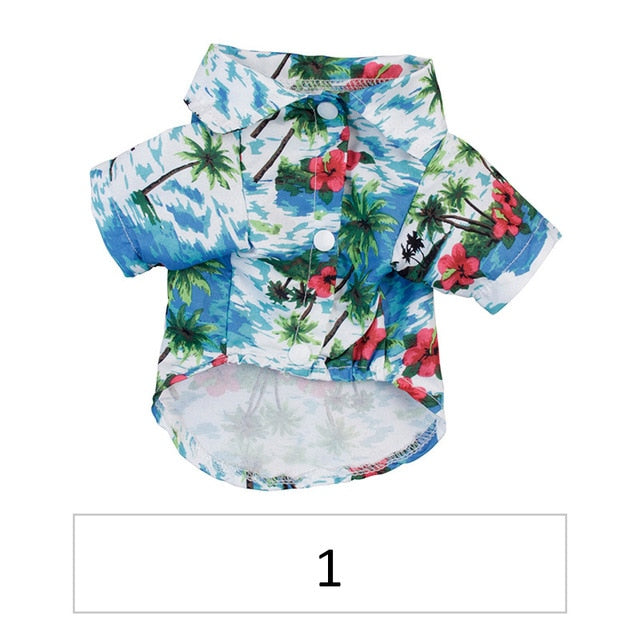 Front view of a blue tropical pet shirt with palm trees and red flowers labeled 1