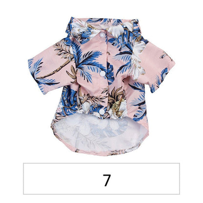 Front view of a pink tropical pet shirt with blue palm leaves labeled 7