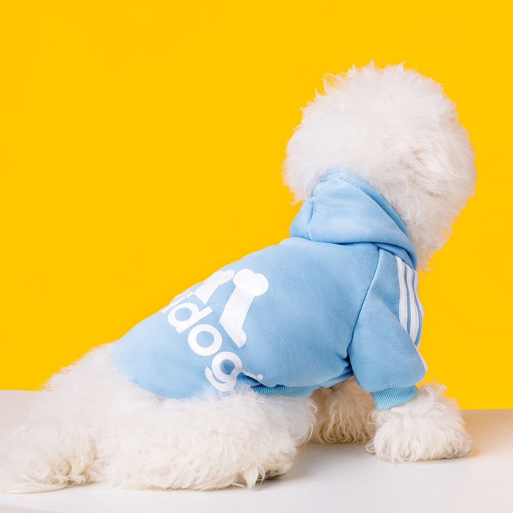 Dog wearing a light blue Adidog hoodie with white back graphics and shoulder stripes

