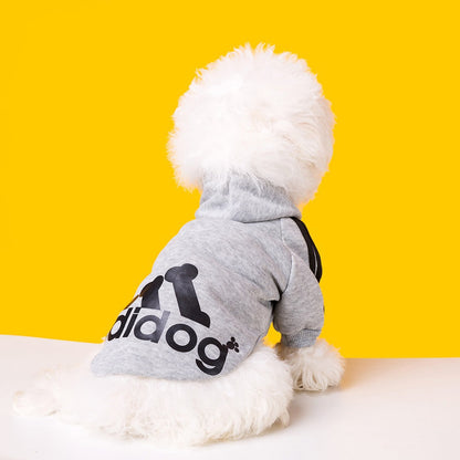 Dog wearing a gray Adidog hoodie with black back graphics