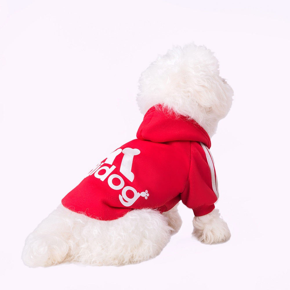 Dog wearing a red Adidog hoodie with white back graphics and shoulder stripes
