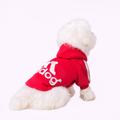 Dog wearing a red Adidog hoodie with white back graphics and shoulder stripes