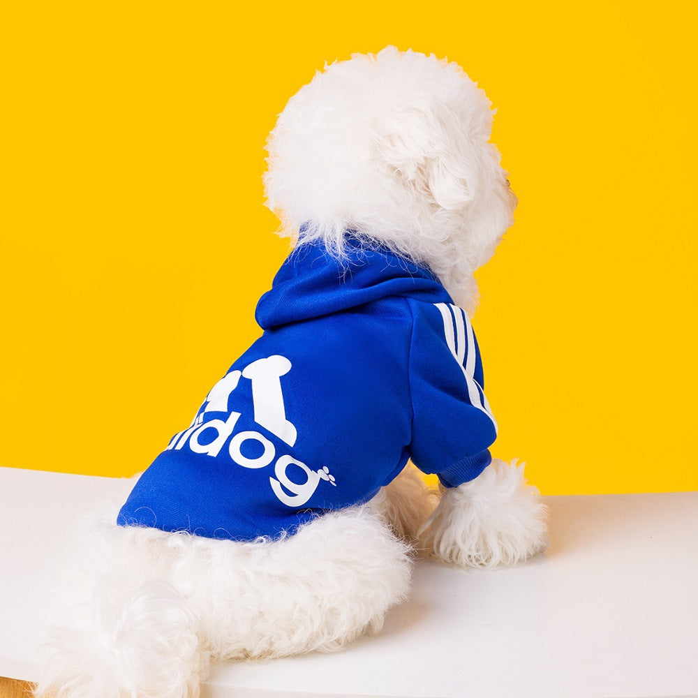 Dog wearing a dark blue Adidog hoodie with white back graphics and shoulder stripes
