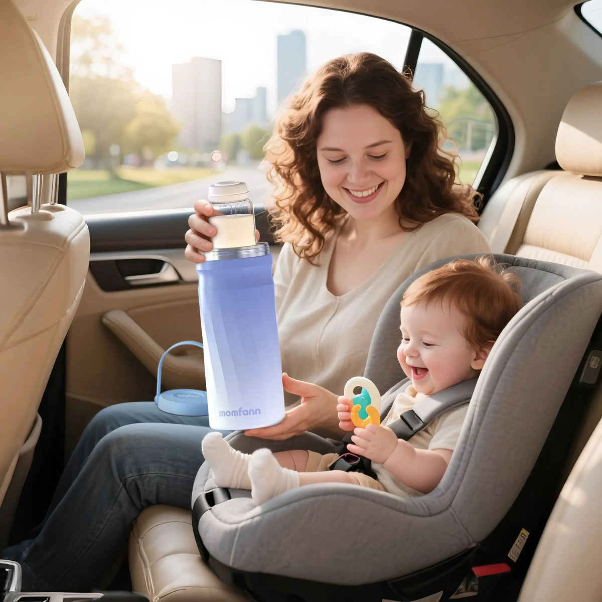 Woman seated beside a child in a car seat, holding a blue Momfann breast milk cooler.