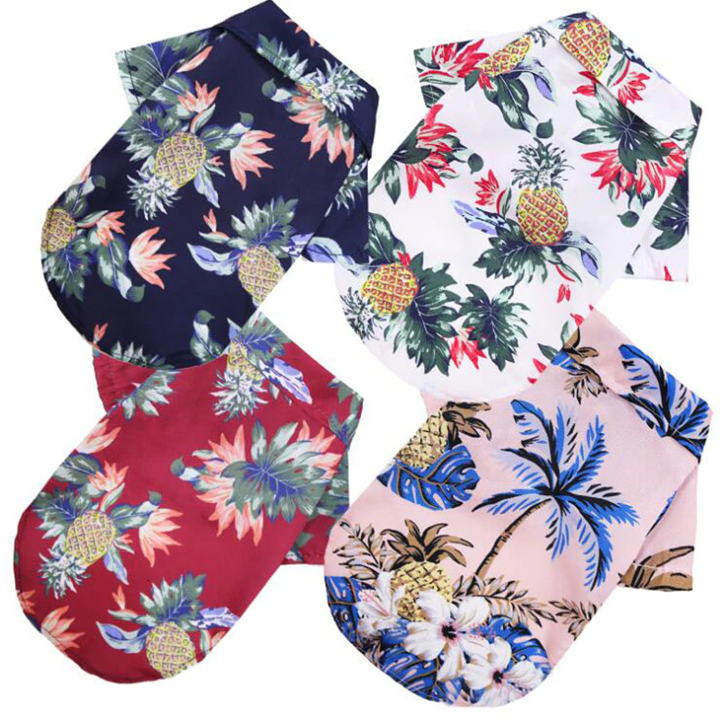Back views of navy white red and pink Hawaiian pet shirts with tropical prints