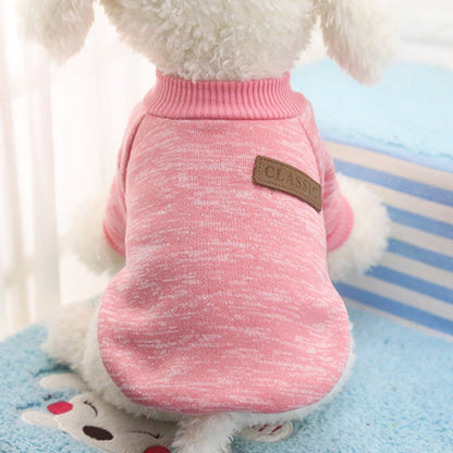 Close-up of a pink pet sweater showing its ribbed neckline and decorative CLASSIC back patch