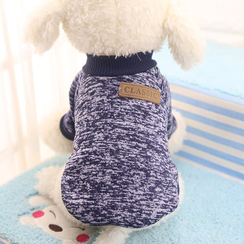 Close-up of a navy marled pet sweater showing its ribbed neckline and decorative CLASSIC back patch