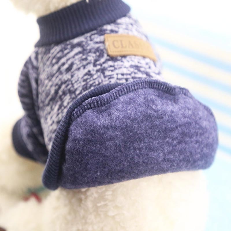 Close-up of the inside fabric and ribbed hem of a navy pet pullover sweater.