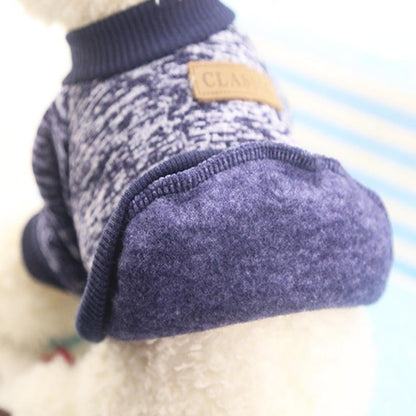 Close-up of the inside fabric and ribbed hem of a navy pet pullover sweater.