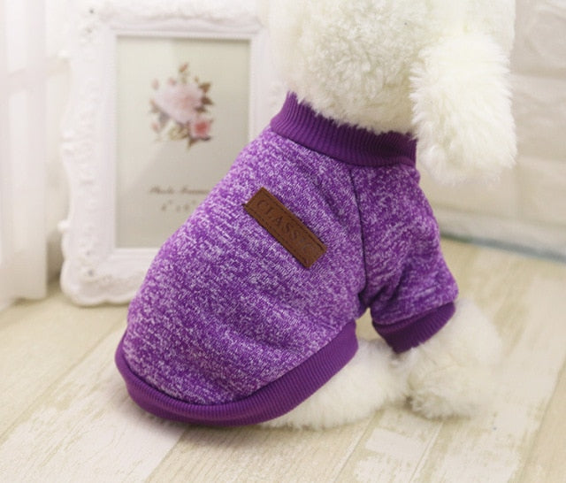 Purple marled pet sweater with short sleeves and ribbed trim, shown from the side on a white plush dog