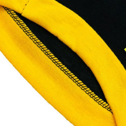 Closeup of the inside seam and yellow trim on a black pet shirt
