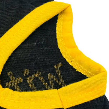 Closeup of yellow armhole trim and stitching on a black pet shirt